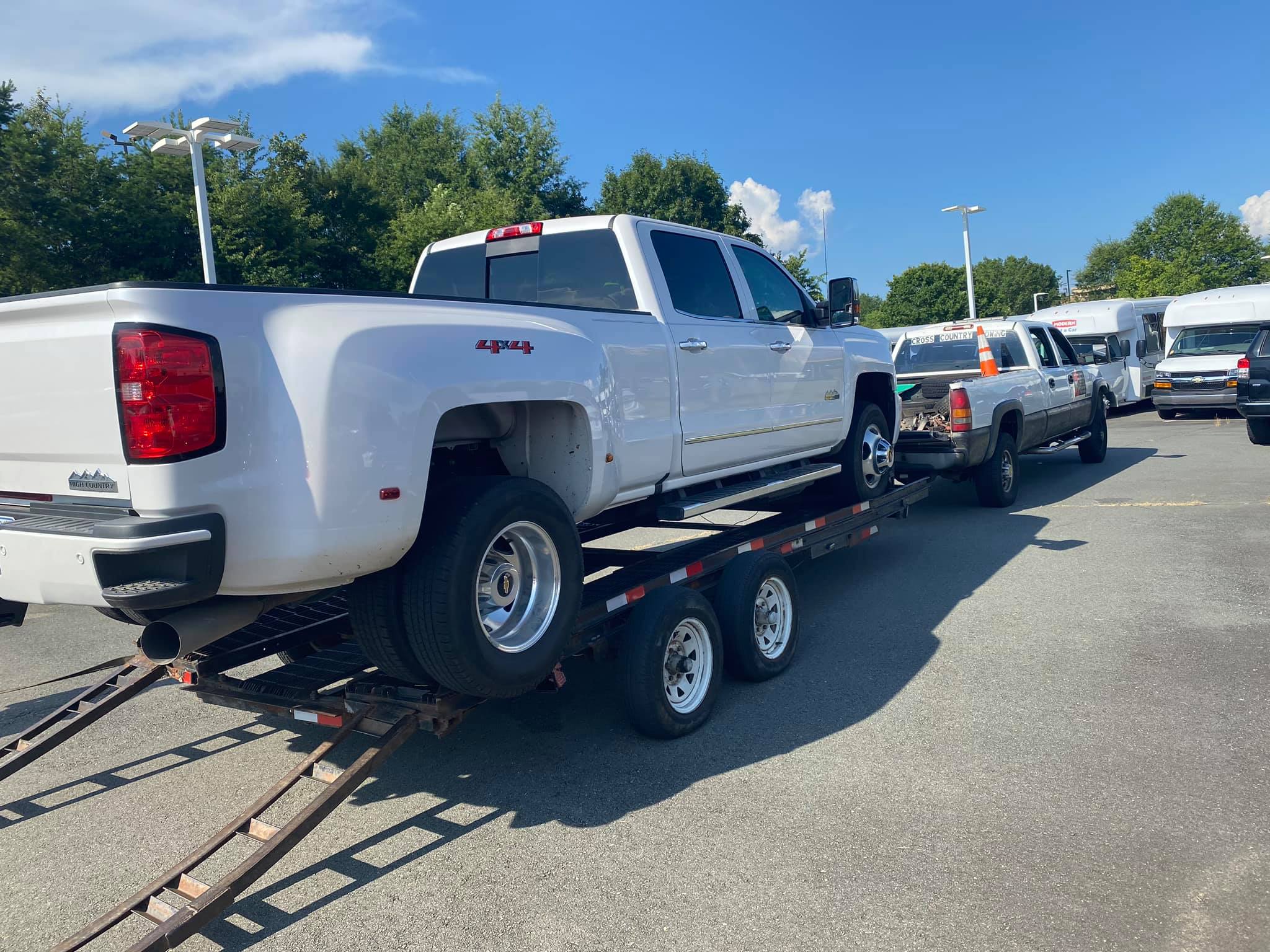 white 4x4 pickup truck towed