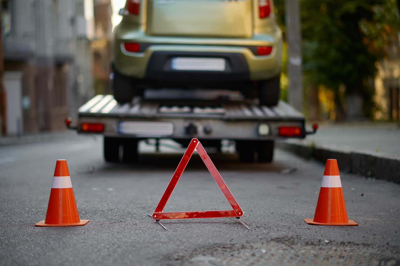 warning triangle and traffic cone on road